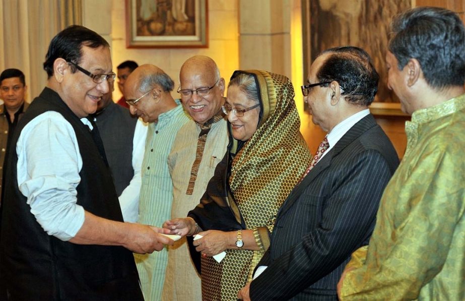 Prime Minister Sheikh Hasina receiving Bank Asia's contribution of Tk 2crore for ICC T-20 World Cup 2014 and Lakho Kanthe Sonar Bangla Tahobil from A Rouf Chowdhury, Chairman of the bank at Gonobhaban on Friday. Finance Minister Abul Maal Abdul Muhith an