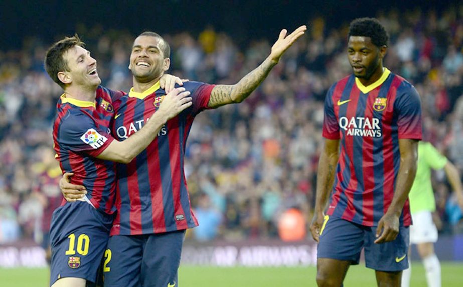 FC Barcelona's Lionel Messi from Argentina (left) celebrates scoring with his teammate Daniel Alves from Brazil during a Spanish La Liga soccer match against Osasuna at the Camp Nou Stadium in Barcelona, Spain on Sunday.