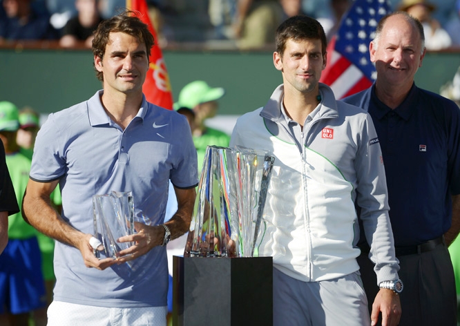 Novak Djokovic (right) of Serbia and Roger Federer of Switzerland pose with their trophies after Djokovic beat Federer 3-6, 6-3, 7-6 to win the final match of the BNP Paribas Open tennis tournament in Indian Wells Calif on Sunday.
