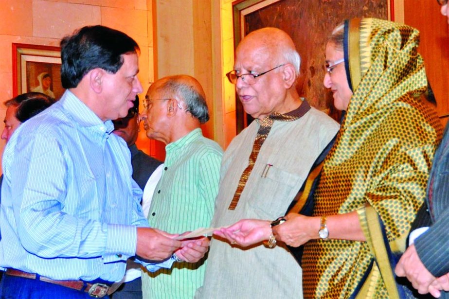 Prime Minister Sheikh Hasina receiving a cheque of Tk 5 million from Managing Director of Jiban Bima Corporation for "Lakho Konthe Jatiya Songit"" fund at Ganobhaban recently. Finance Minister Abul Maal Abdul Muhith also seen in the picture."