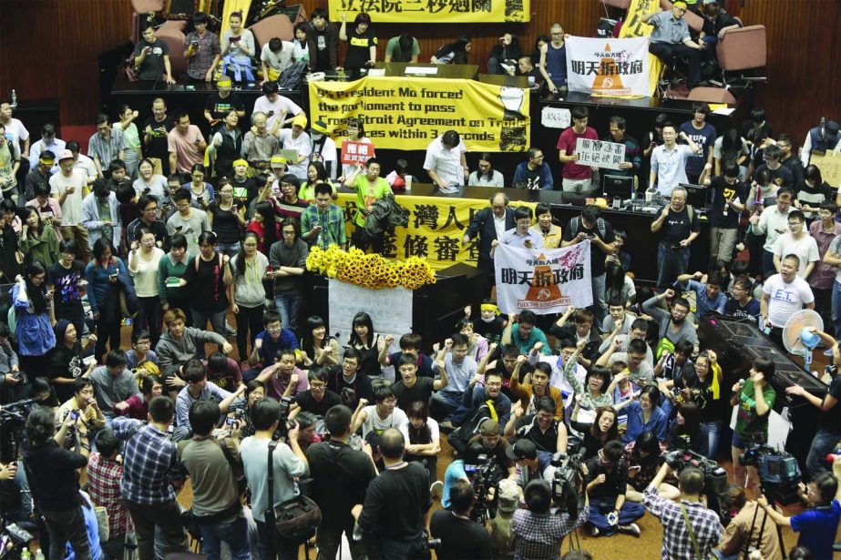 Students and protestors occupy the Taiwanese Parliament to protest against the act by the ruling Kuomintang party to ratify a controversial service and trade agreement with China on Wednesday.