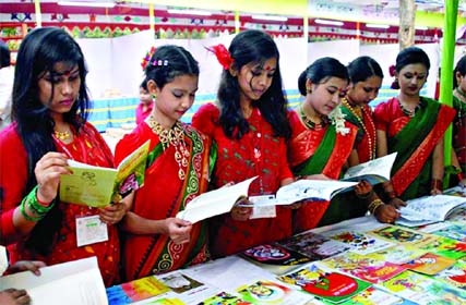 Visitors flip through the books at a stall of a week-long book fair organized by Bangladesh Shishu Academy at its premises in the city. The snap was taken on Wednesday.