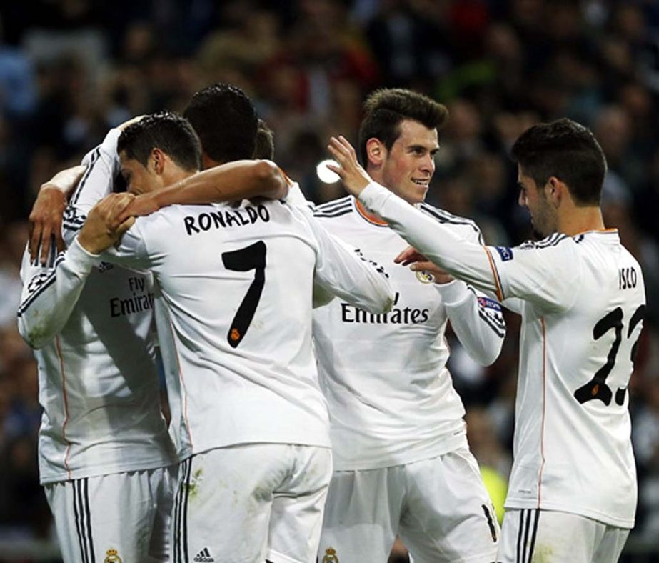 Real's Alvaro Morata (left) celebrates his goal with teammates during a Champions League round of 16 second leg soccer match between Real Madrid and FC Schalke 04 at the Santiago Bernabeu stadium in Madrid on Tuesday.