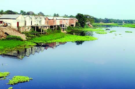 JHENIDAH: A section of influential people constructed market grabbing the bank of the River Kumar at Shailakupa Upazila in the district. This picture was taken from Kabirpur Bridge area on Wednesday.