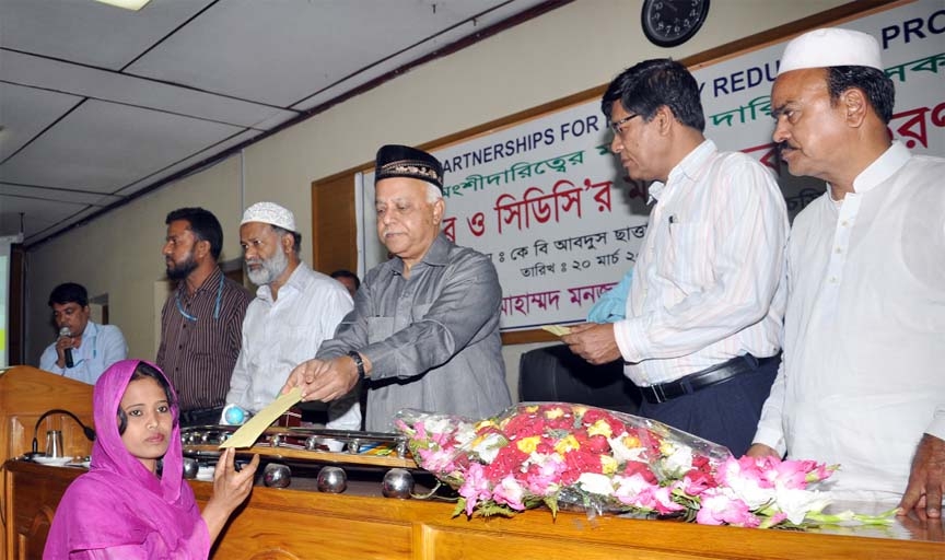 CCC Mayor M Monzoor Alam distributing cheque among the beneficiaries of Poverty Alleviation Project with the participation of city corporation at a function in Chittagong yesterday.