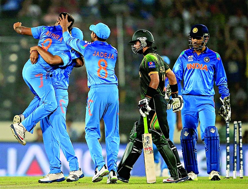 Indian players celebrate after getting Ahmed Shehzad stumped during the World Cup Twenty20 match between India and Pakistan in Mirpur National Stadium on Friday.