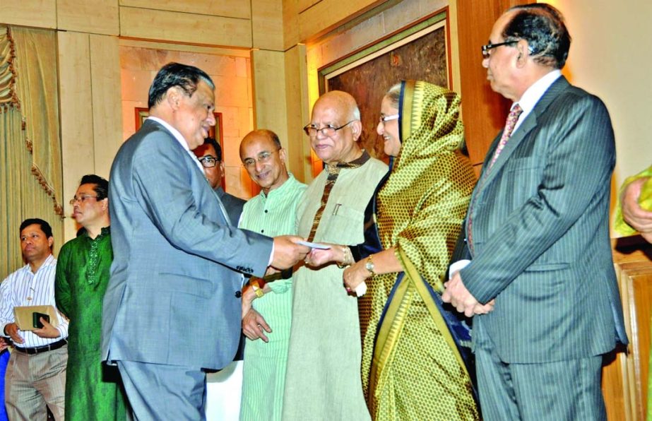 Prime Minister receiving a cheque of Tk 1 crore for 'Lakho Konthe Sonar Bangla' fund from Chairman of United Commercial Bank Limited MA Hashem at Ganobhaban recently. Finance Minister Abul Maal Abdul Muhith and prime minister's adviser Dr Towfiq-e-Elah