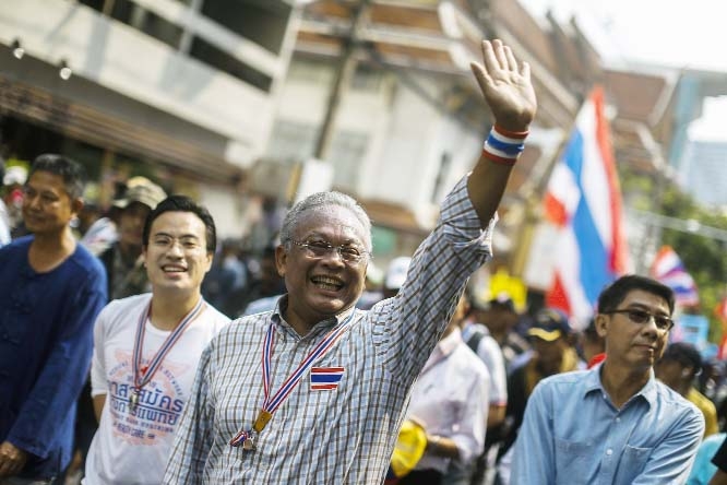 Protest leader Suthep Thaugsuban greets to his supporters during a rally in central of Bangkok on Monday.