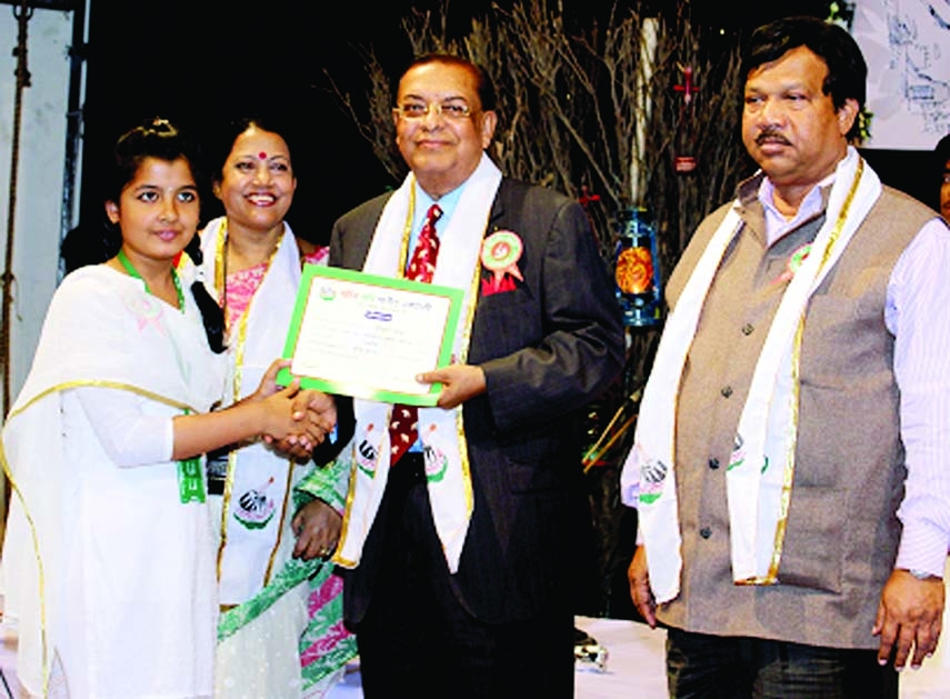 Dr M Mosharraf Hossain, Chairman and Managing Director, Rapport Bangladesh Limited is seen presenting certificate to a successful passed out student of Lalon Sangeet in a Certificate Awarding Ceremony arranged recently by Farida Parveen Foundation held at