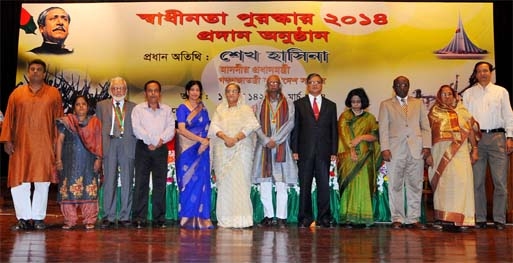 Prime Minister Sheikh Hasina at a photo session with the recipients of Independence Award 2014 at the city's Osmani Memorial Auditorium on Tuesday. Photo PID