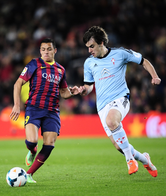 FC Barcelona's Alexis Sanchez from Chile (left) duels for the ball against Celta Vigo's Jon Aurtenetxe during a Spanish La Liga soccer match at the Camp Nou stadium in Barcelona, Spain on Wednesday.