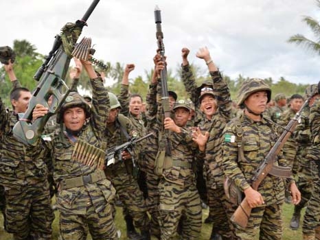 Moro Islamic Liberation Front (MILF) rebels celebrate the signing of the peace agreement during a rally at Camp Darapanan, in the southern island of Mindanao.