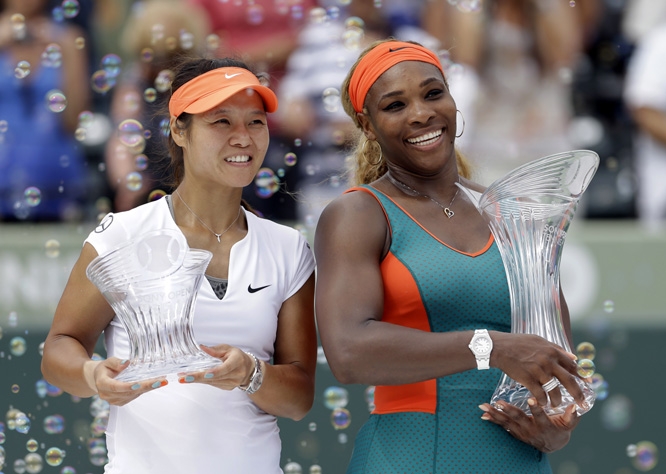 Serena Williams (right) of the United States and Li Na of China pose for photos after the trophy presentation for the women's final at the Sony Open Tennis tournament in Key Biscayne, Fla on Saturday. Williams won 7-5, 6-1.