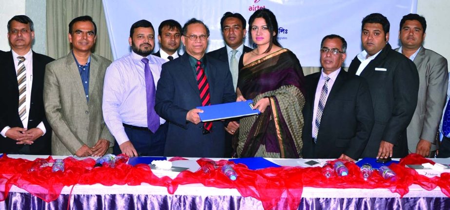 Md. Omar Faruque Bhuiyan, Executive Vice President of NCC Bank and Rubaba Dowla, Chief Service Officer of Airtel Bangladesh handing over the documents after signing an agreement to provide mobile banking services to Airtel subscribers.