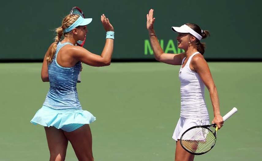 Martina Hingis of Switzerland (R) and Sabine Lisicki of Germany celebrate match point against Ekaterina Makarova and Elena Vesnina of Russia in Key Biscayne, Florida, on Monday.