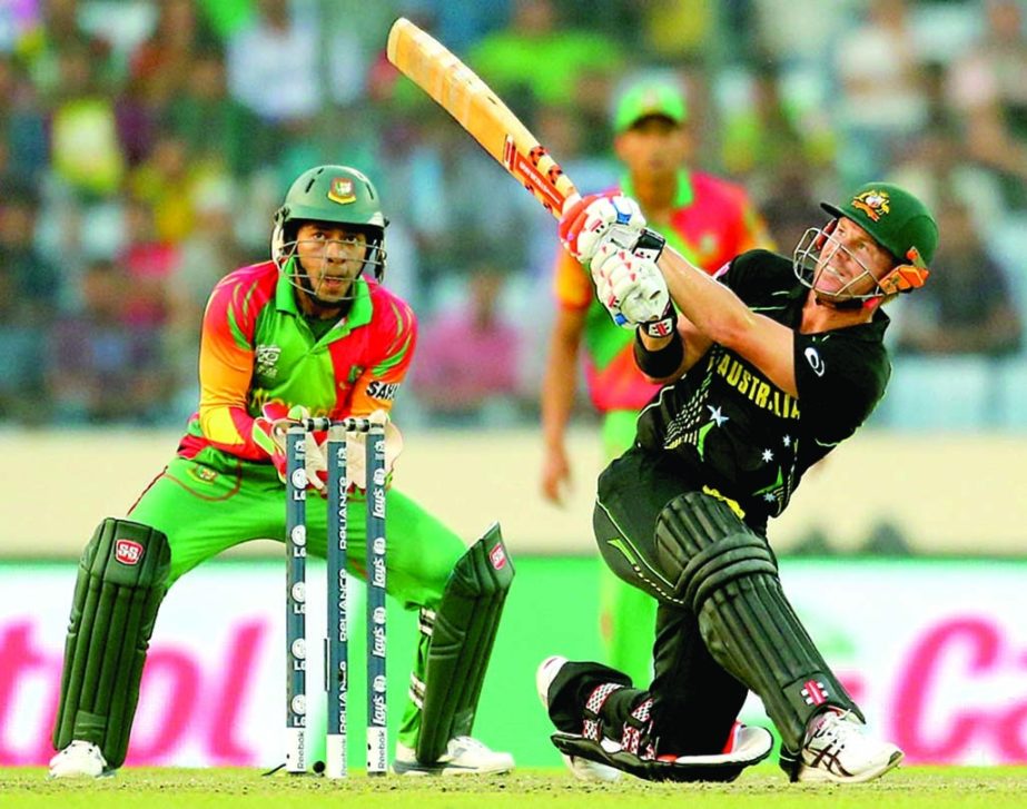 David Warner slogs during his 48 during the World T20, Group 2 match between Bangladesh and Australia at Mirpur on Tuesday.Photo Agency