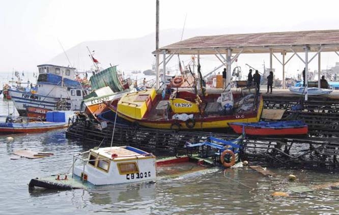 Sunken fishing boats in Iquique, northern Chile, on Wednesday Despite the strength of the quake, the region appears to have escaped significant damage.