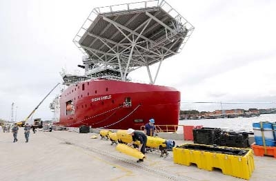 Workers assemble a Blue Fin 21 automatic Underwater Vehicle, an autonomous sonar mapping device, which will be towed behind the Australian Defence Vessel Ocean Shield during search operations for missing Malaysia Airlines flight MH370.