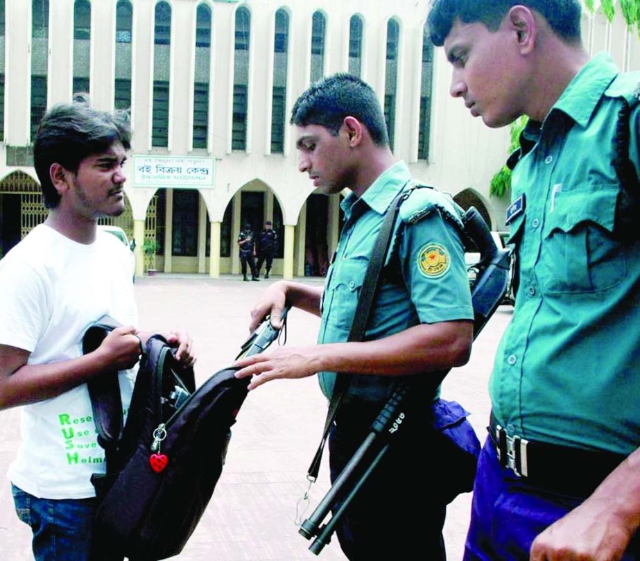 Law enforcers checking bags of people at the gate of Baitul Mokarram National Mosque in the city during Jumma prayers.