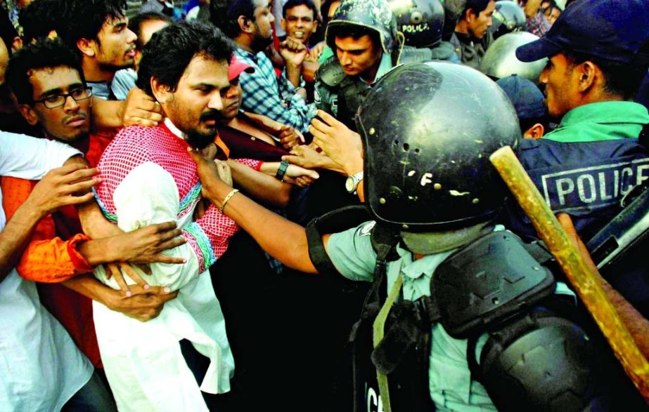 Ganajagoran Mancha spokesperson Imran H Sarker being assaulted by the police on Friday while trying to hold a rally in city's Shahbagh area on Friday.
