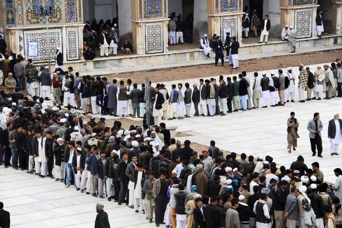 Afghan voters lined up for blocks at polling stations nationwide on Saturday, defying a threat of violence by the Taliban to cast ballots in what promises to be the nation's first democratic transfer of power.