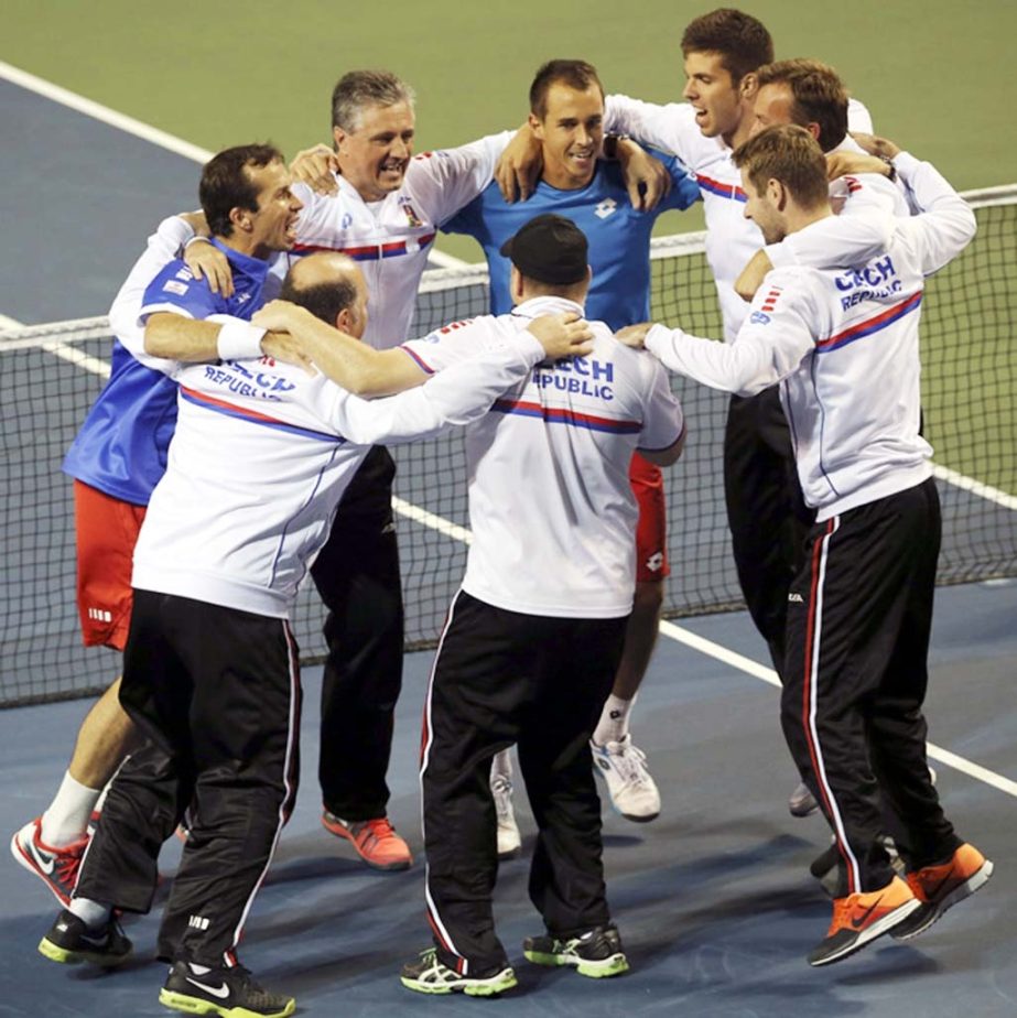 Lukas Rosol (center top) Radek Stepanek (left) and other team members of the Czech Republic celebrate after defeating Japan during quarterfinal of Davis Cup World Group tennis at Ariake Colosseum in Tokyo on Saturday.