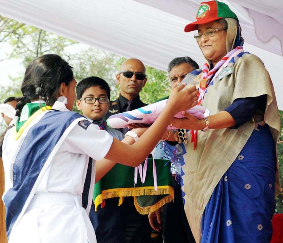 Prime Minister Sheikh Hasina handing over Jambooree Flag to a scout at the inauguration of Scouts Jambooree at the National Scouts Training Center at Mouchak in Gazipur on Saturday. BSS photo