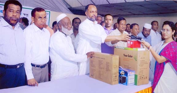 M Abdul Latif MP distributing computers among the students of different educational institutions of Chittagong -12 Constituency at a function yesterday.
