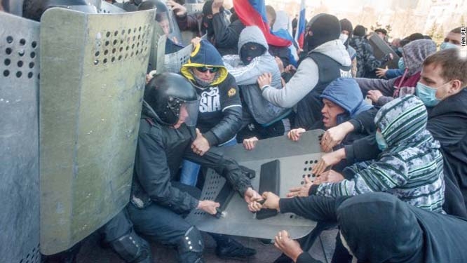 Pro-Russian protesters clash with police as they try to occupy a regional administration building in Donetsk, Ukraine, on Sunday.