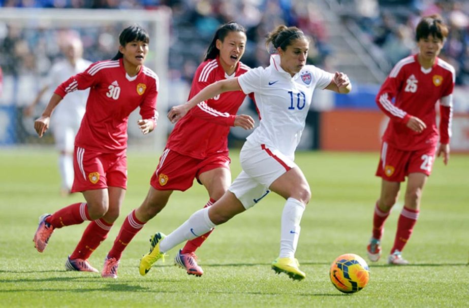 US midfielder Carli Lloyd (10) moves the ball upfield against China's Lui Shanshan (30), Zhang Xin and Zhang Rui (25) during the second half of an international friendly soccer match in Commerce City, Colo on Sunday. The United States won 2-0.