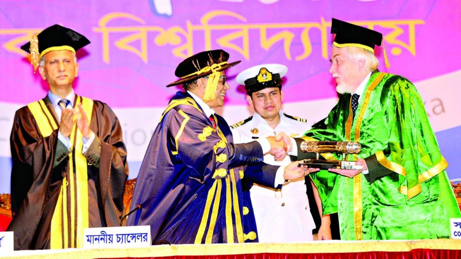 President and Chancellor Abdul Hamid confers the Doctor of Science degree upon Director General of European Organisation for Nuclear Research Prof Dr Rolf Dieter Heur at Dhaka University (DU) playground on Monday on the occasion of 48th Convocation of DU.