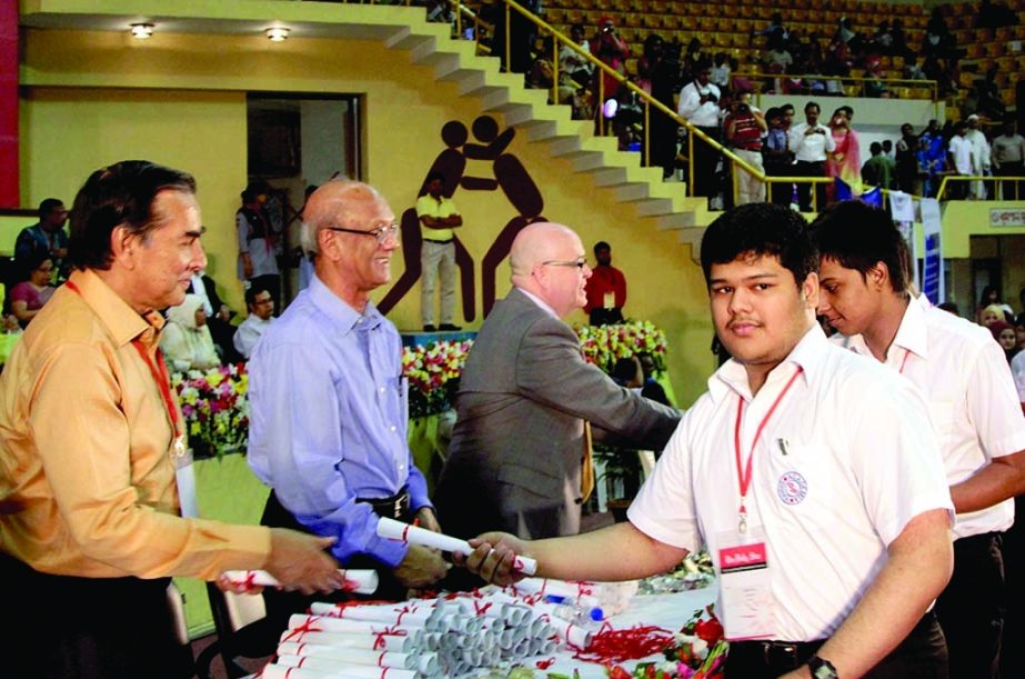Galib Huq, a student of Academia receiving award recently from Mahfuz Anam, Editor & Publisher of The Daily Star at the National Indoor Stadium in the city's Mirpur. Education Minister Nurul Islam Nahid was present, among others.