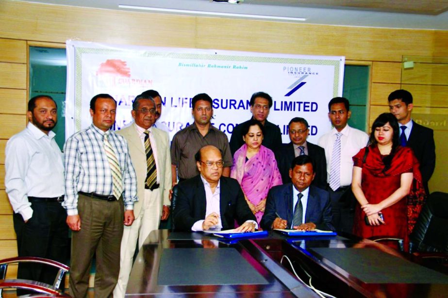 QAFM Serajul Islam, Managing Director of Pioneer Insurance Company Ltd and Noor Mohammed Bhuiyan, Managing Director of Guardian Life Insurance Limited sign the contract for Group Life Insurance coverage to the employees of Pioneer Insurance at the Guardia