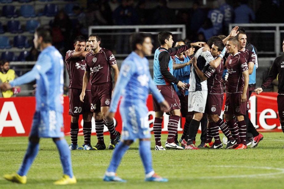 Argentina's Lanus' players celebrate after their Copa Libertadores soccer match with Chile's O'Higgins ended 0-0, classifying their team for the next round in Rancagua Chile on Tuesday.