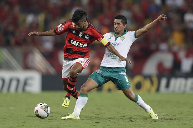 Leo Moura of Brazil's Flamengo, left, fights for the ball with Elias Hernan Hernandez of Mexico's Leon during a Copa Libertadores soccer match in Rio de Janeiro, Brazil on Wednesday.