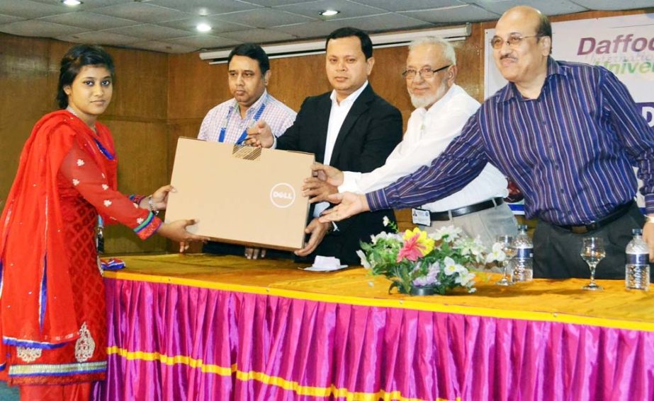 Md. Sabur Khan, Chairman, Board of Trustees, Daffodil International University handing over a laptop to a student at the Laptop Distribution Program on Thursday.