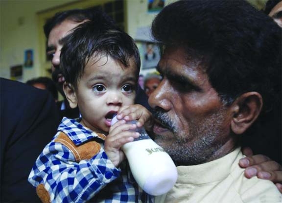 Defiant toddler Young Muhammad Musa Khan outside court in Lahore, after being cleared of attempting to murder a group of policemen.