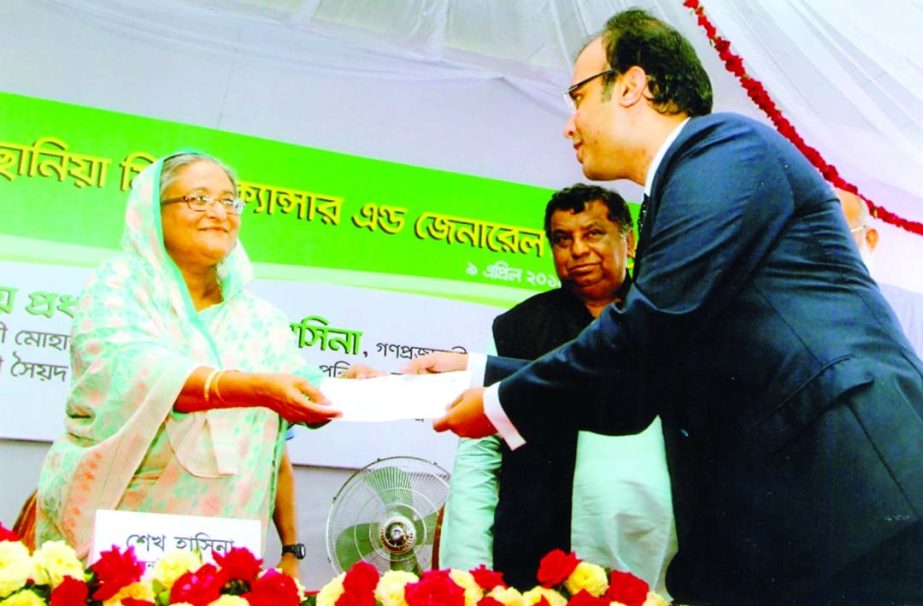 Prime Minister Sheikh Hasina receiving a cheque of Tk 15 crore from Dutch-Bangla Bank Chairman Sayem Ahmed when she inaugurating Ahsania Mission Cancer and General Hospital Complex at Uttara on Wednesday.