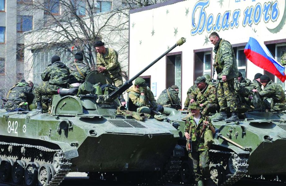 Armed men wearing military fatigues stand guard by armoured personnel carriers outside the regional state building seized by pro-Russian separatists in the eastern Ukrainian city of Slaviansk.