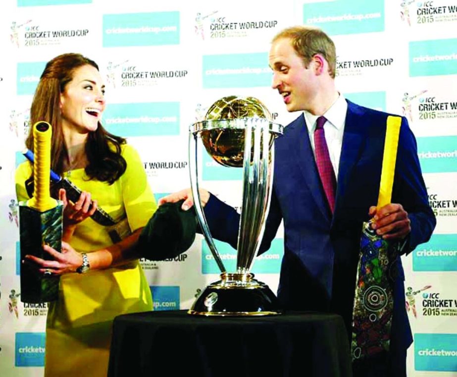 Britain's Prince William (right) and his wife Kate, the Duchess of Cambridge, hold cricket bats presented to them in front of the Cricket World Cup during a reception at the Sydney Opera House on Wednesday. The royal couple, along with their son Prince G