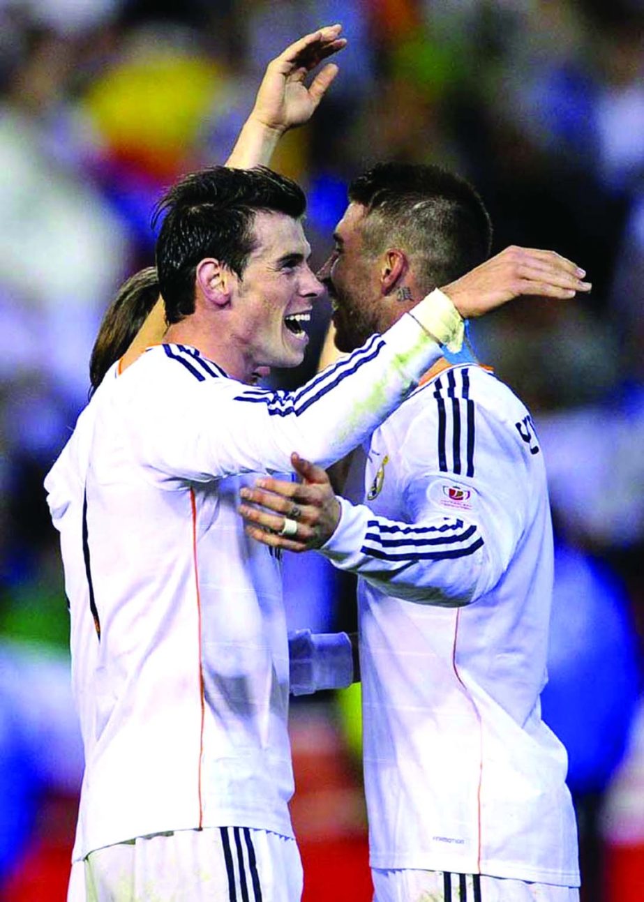Real's Gareth Bale (left) celebrates with Sergio Ramos at the end of the final of the Copa del Rey between FC Barcelona and Real Madrid at the Mestalla stadium in Valencia, Spain on Wednesday.