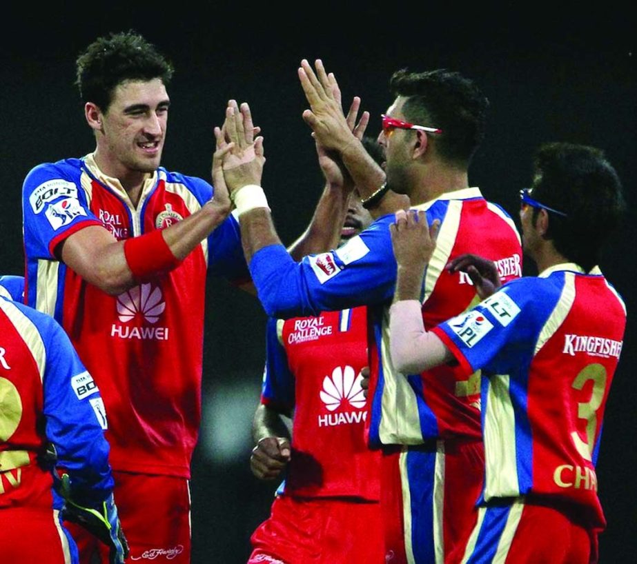 Mitchell Starc celebrates his first wicket for Bangalore against Delhi in Indian Premier League at Sharjah on Thursday.