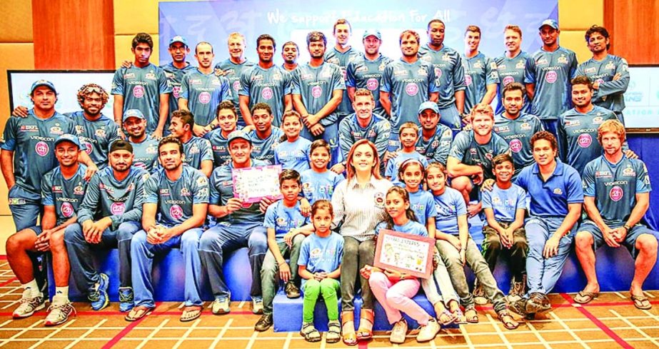 Mumbai players and staff pose with nine underprivileged children from Mumbai as part of the 'Education for All' initiative in Dubai on Friday.