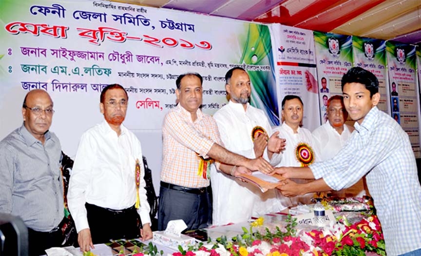 State Minister of Land Saifuzzaman Chowdhury MP distributing scholarship organised by Feni Zilla Samity, Chittagong yesterday.