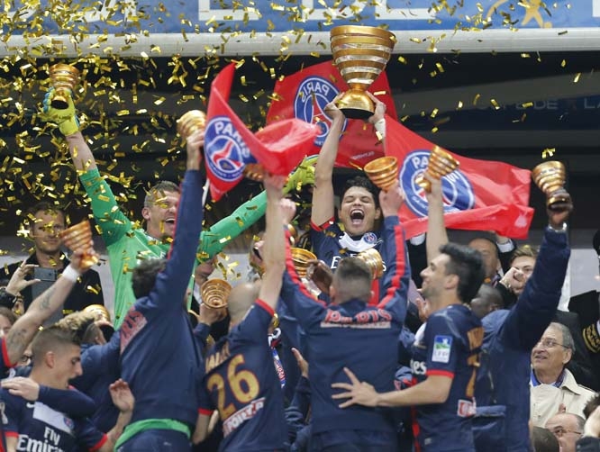 Paris Saint Germain's Thiago Motta (center) of Italy and teammates celebrate with the cup after winning their French League Cup final soccer match against Lyon at the Stade de France in Saint Denis, north of Paris on Saturday.