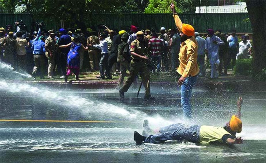 Police use water cannons to disperse activists from the Akali Dal and victims of the 1984 anti-Sikh riots during a protest outside Congress headquarters in New Delhi.