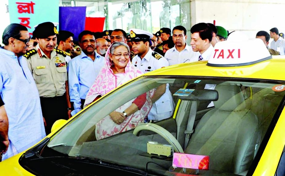 Prime Minister Sheikh Hasina inaugurating Army Welfare Trust Taxicab Service at Army Golf Club in the city on Tuesday. BSS photo