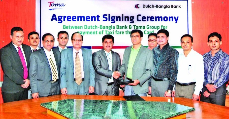 Mohd Ataur Rahman Bhuiyan (Manik), Managing Director of Toma Group and Md Kamruzzaman, Head of Personal Banking Division of DBBL sign an agreement recently to facilitate the passengers to pay their taxi fare through POS terminals. From now passengers thos