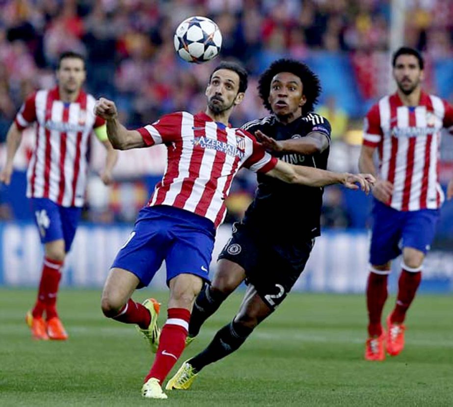 Atletico's Juanfran (left) clears the ball from Chelsea's Willian during the Champions League semifinal first leg soccer match between Atletico Madrid and Chelsea at the Vicente Calderon stadium in Madrid, Spain on Tuesday.