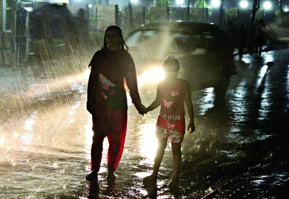 Some city dwellers came out on the street on Saturday evening when a brief drizzle brought a sigh of relief after a week's scorching heat across the country. This photo was taken from Bashundhara area on Saturday.